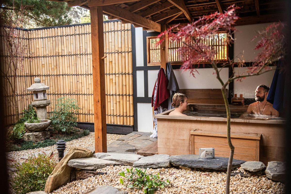 A couple relaxing in the hinoki timber bath before heading in for their massage.