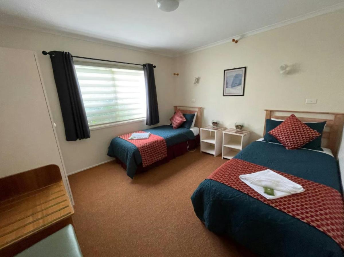 Two single beds in a large bedroom