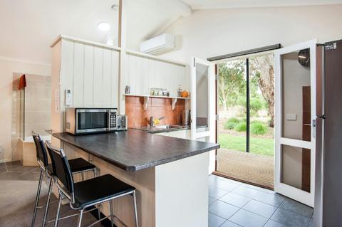 Modern kitchen leading to the decking with mountain views