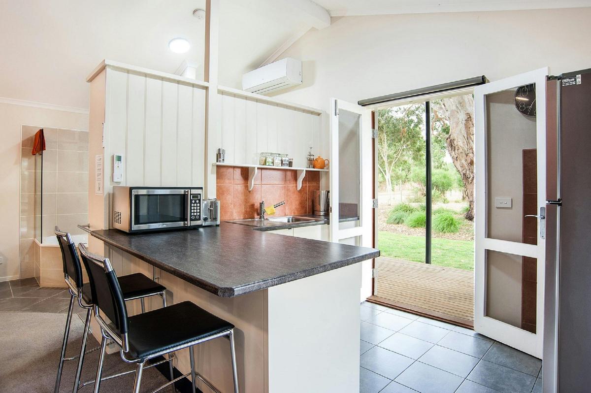 Modern kitchen leading to the decking with mountain views