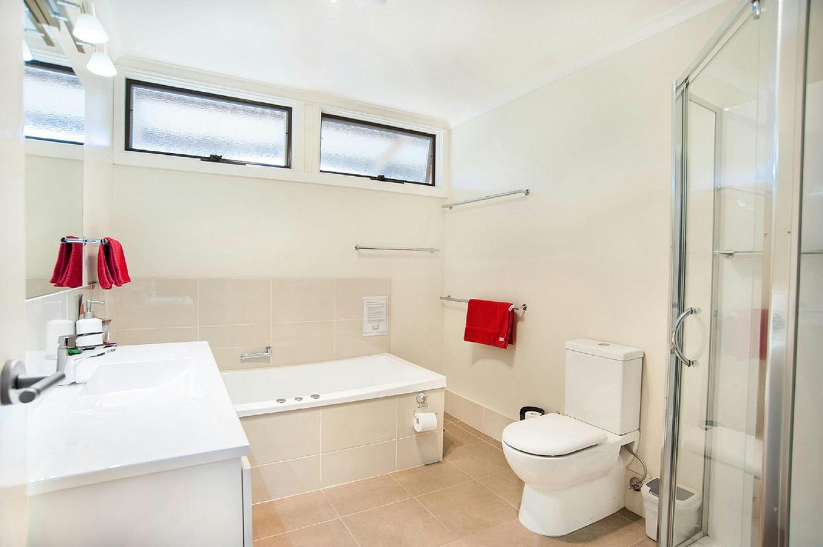 Spacious bathroom with separate shower and spa bath