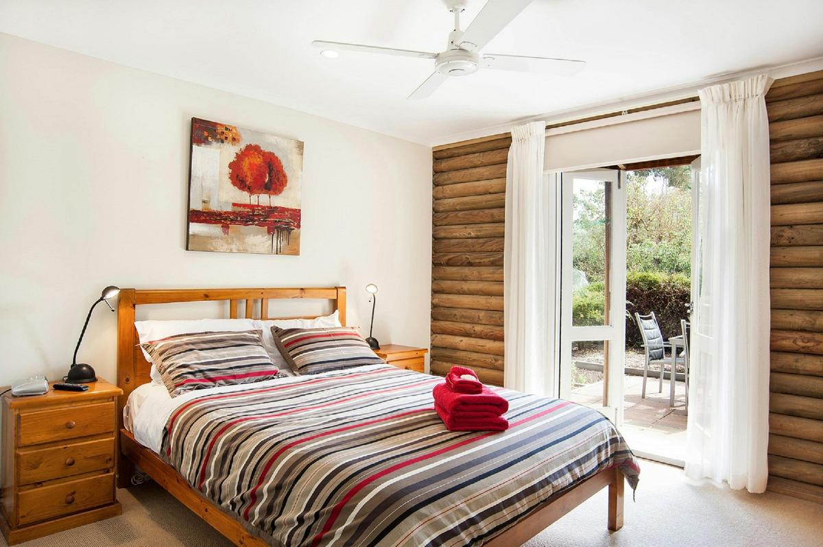 Spacious bedroom with french doors opening out to patio