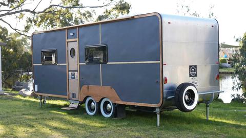 HV1 silver caravan with wooden accents parked by the riverside at Stawell Grampians Gate Hotel Motel