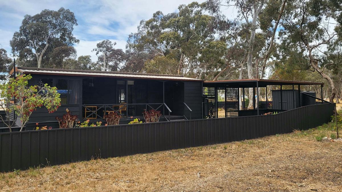 Spacious black cabin 88 with a large covered porch and yard at Stawell Grampians Gate Hotel Motel