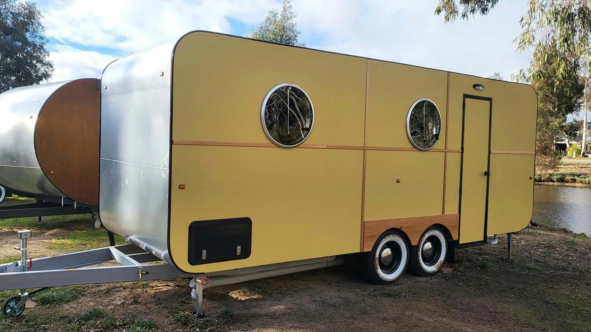 Bright yellow caravan HV7 with round windows at Stawell Grampians Gate Hotel Motel