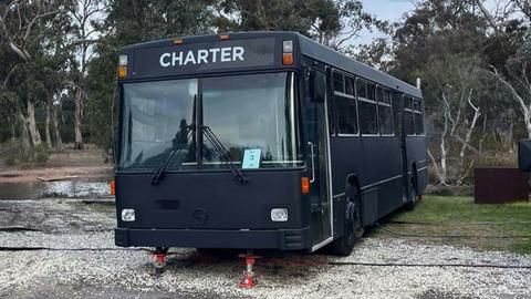 Black Bus 3, labeled "Charter," converted into accommodation, at Stawell Grampians Gate Hotel Motel
