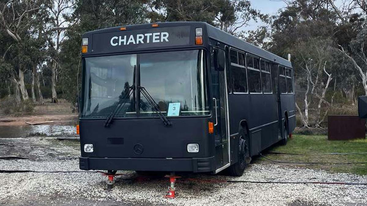 Black Bus 3, labeled "Charter," converted into accommodation, at Stawell Grampians Gate Hotel Motel