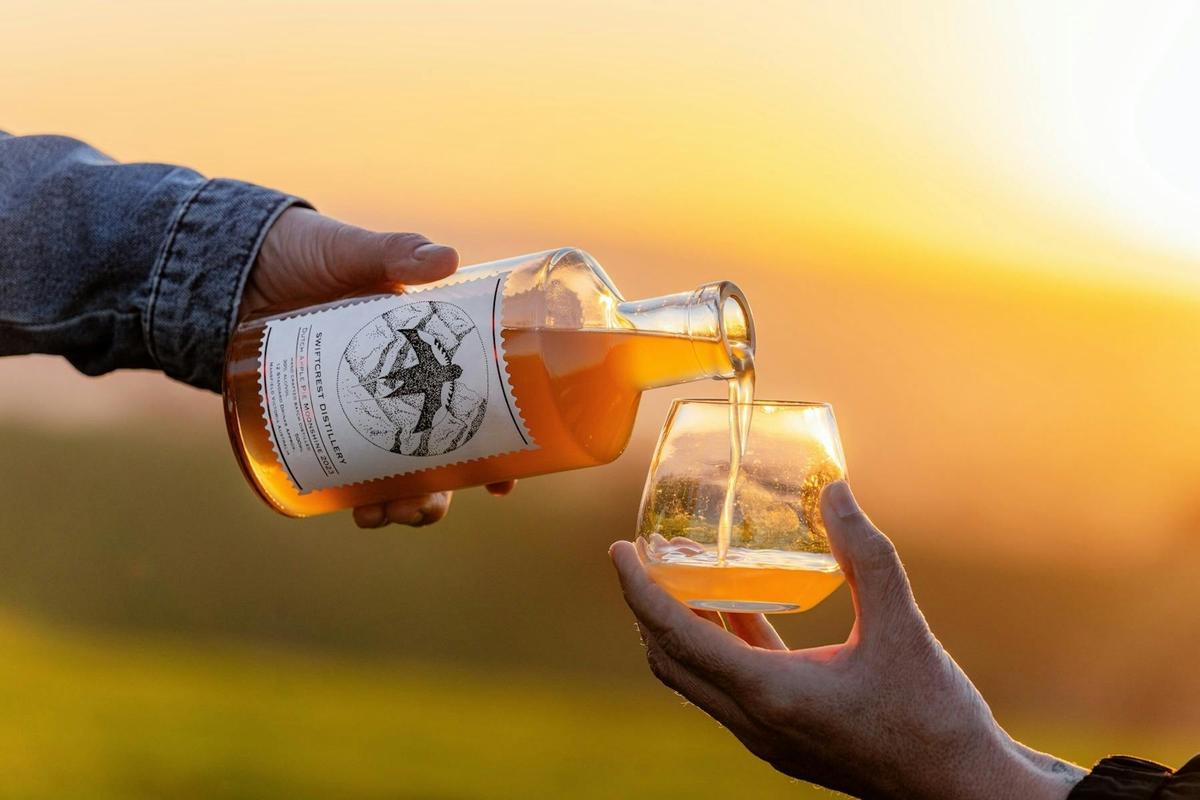 Golden hour drinks - enjoying Swiftcrest Distillery gin poured fresh as the sun sets over the hills.