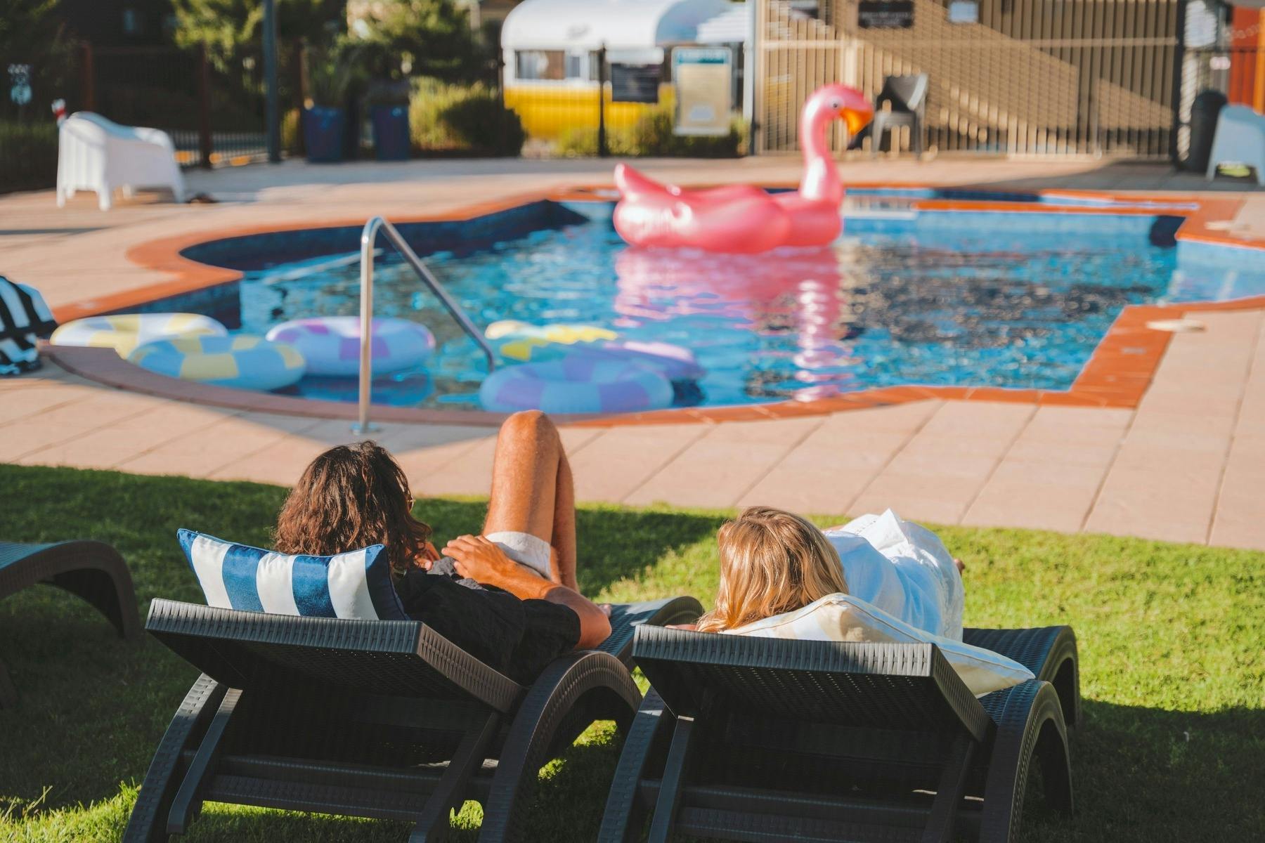 People relaxing by a swimming pool