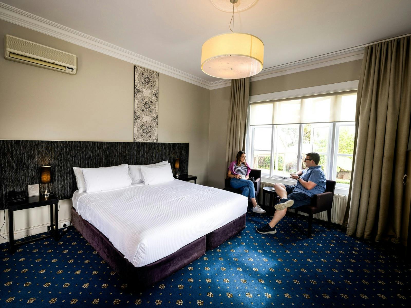 Man and woman seated inside a room