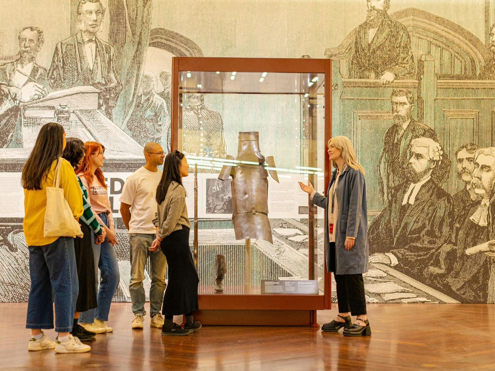 A tour group learning about Ned Kelly and his armour at the Library