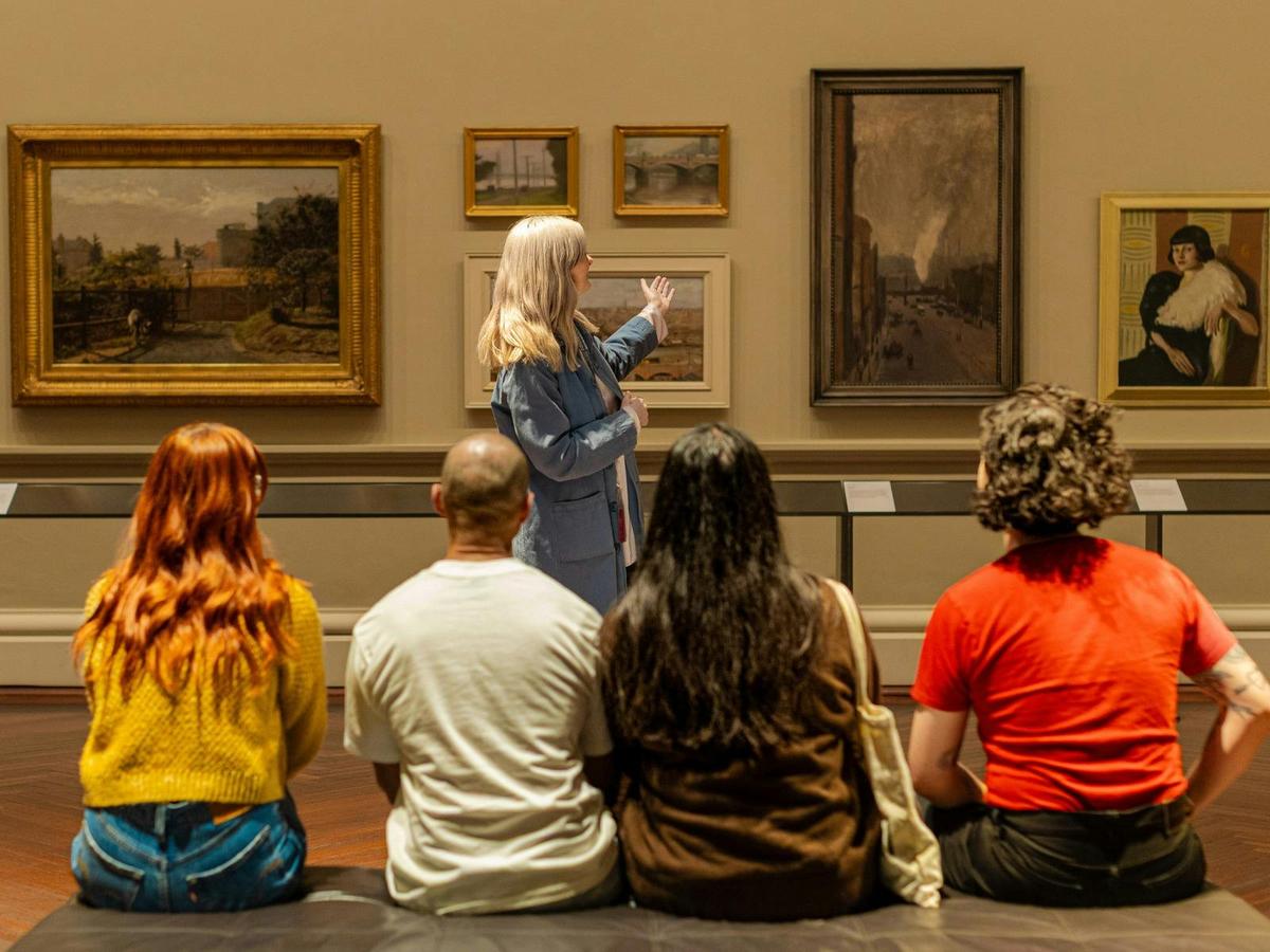 A tour group being led through the gallery