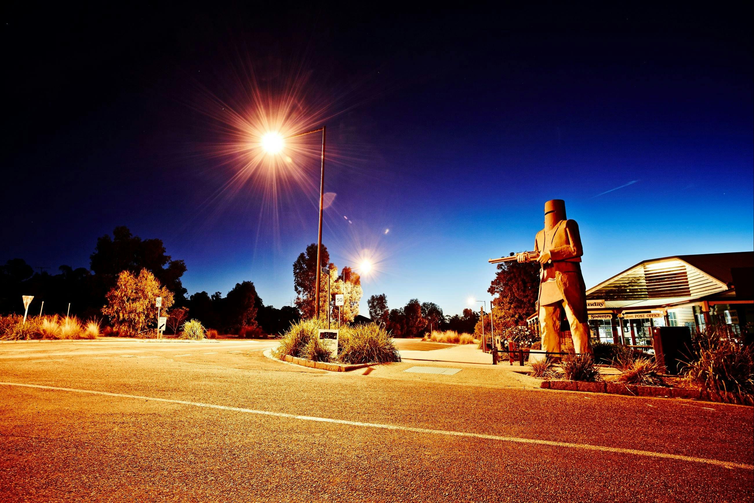 Statue lit up at night time.