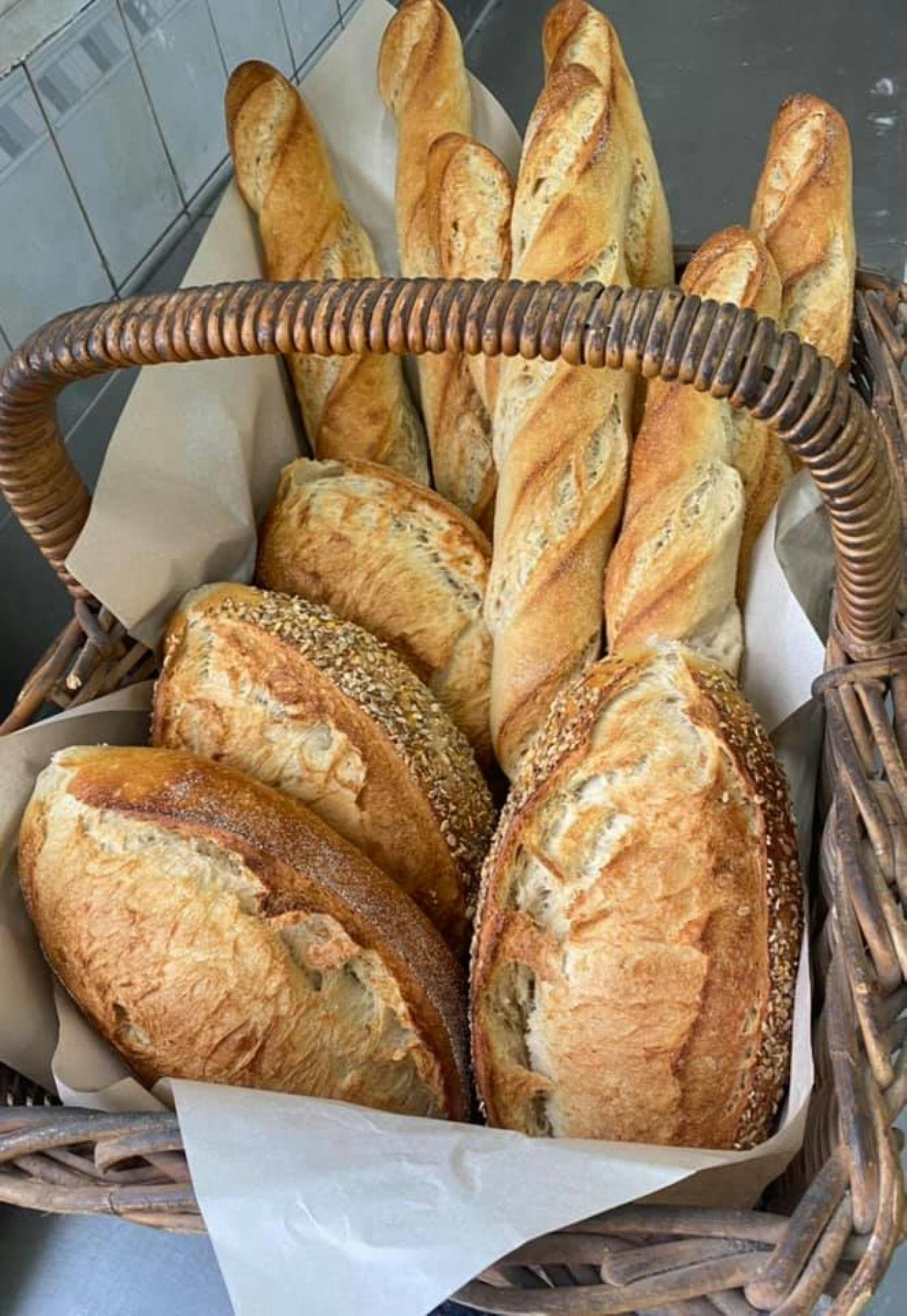 A basket of different types of breads and rolls