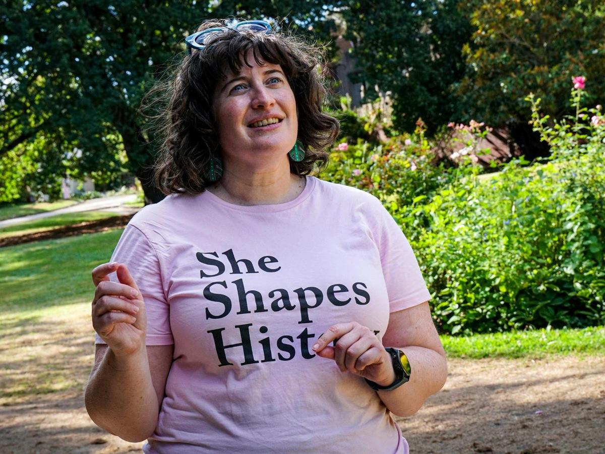 She Shapes History tour guide presenting to the group of engaged guests