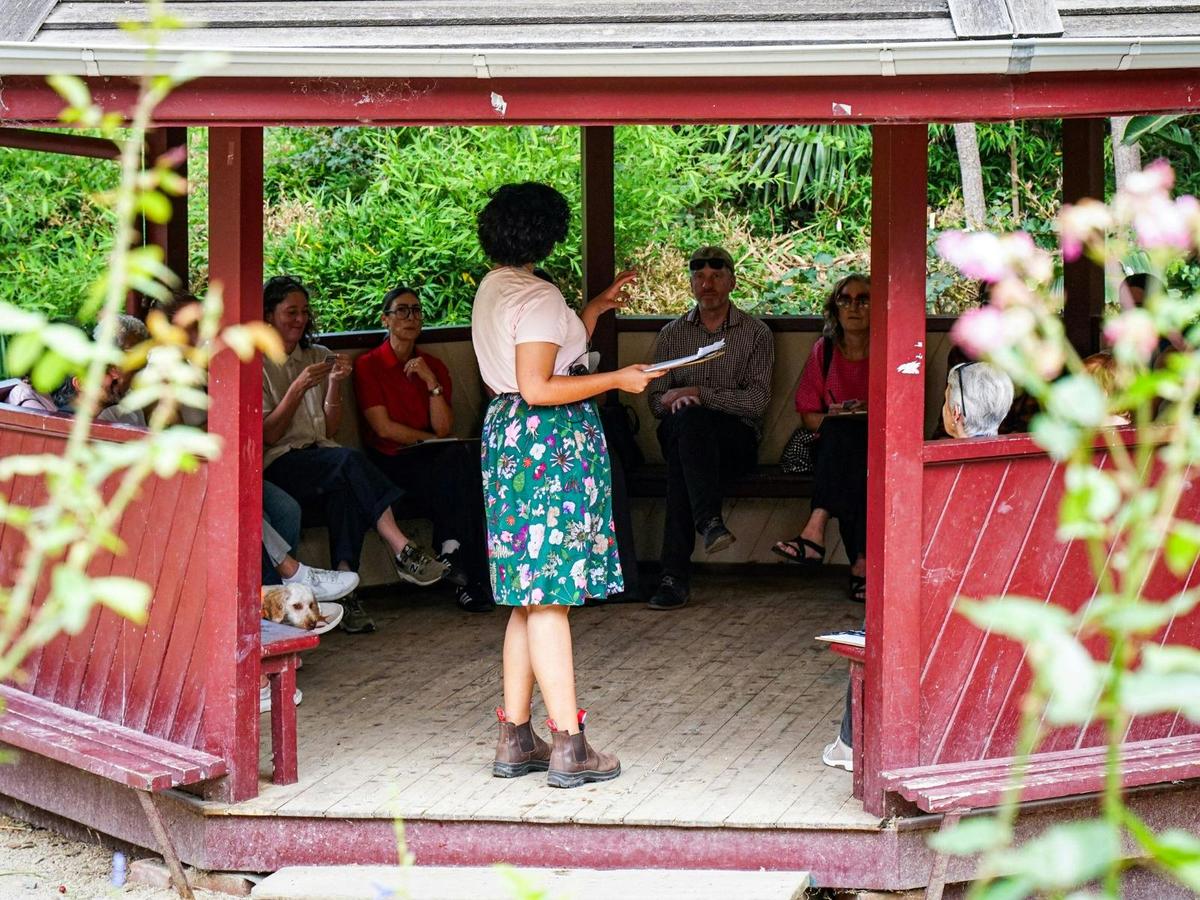 She Shapes History tour guide presenting to the group of engaged guests
