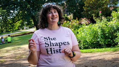 She Shapes History tour guide presenting to the group of engaged guests