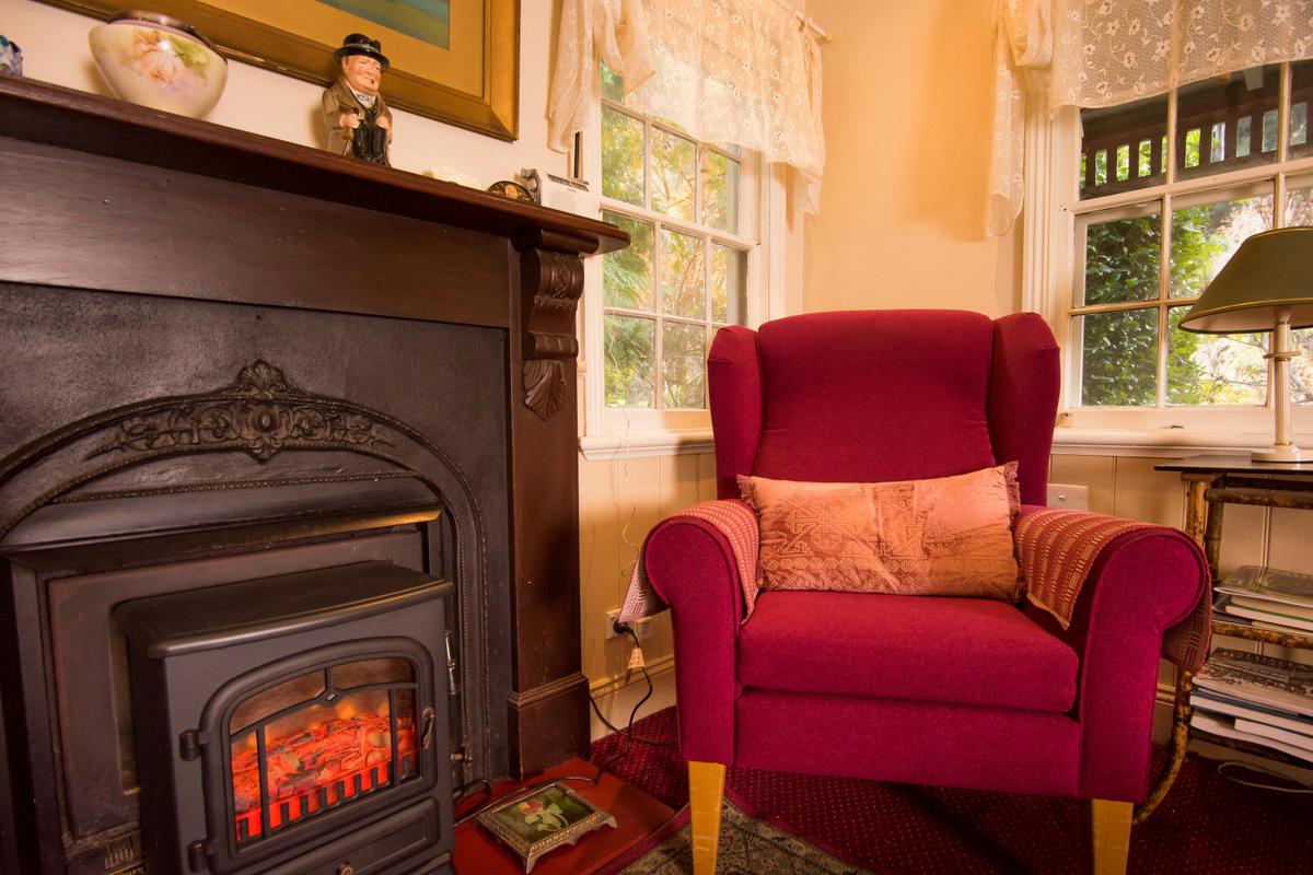 Armchair beside the electric fire in the loungeroom