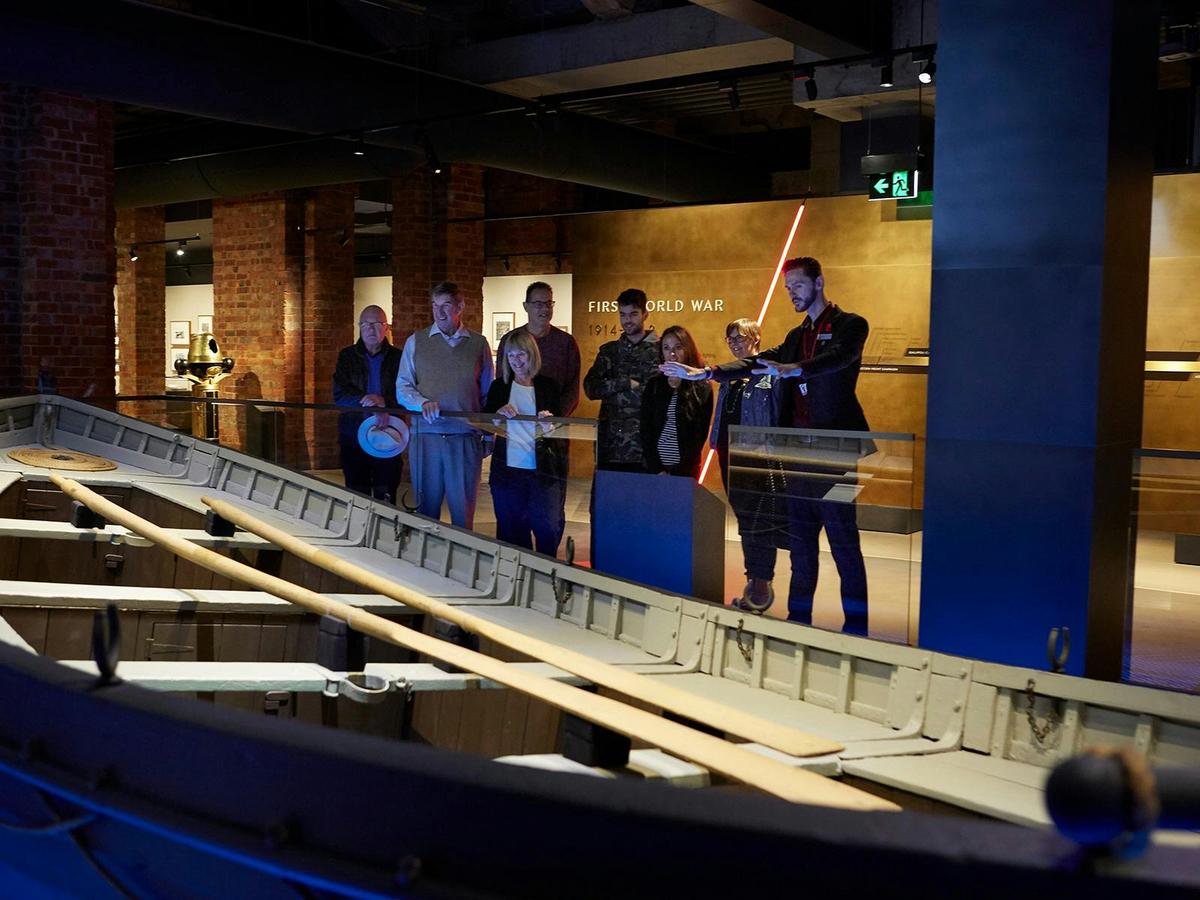 Tour Guide stands with tour participants inside the Shrine of Remembrance Galleries