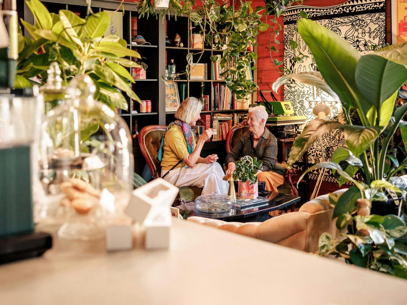 Two people sitting drinking coffee inside Cafe