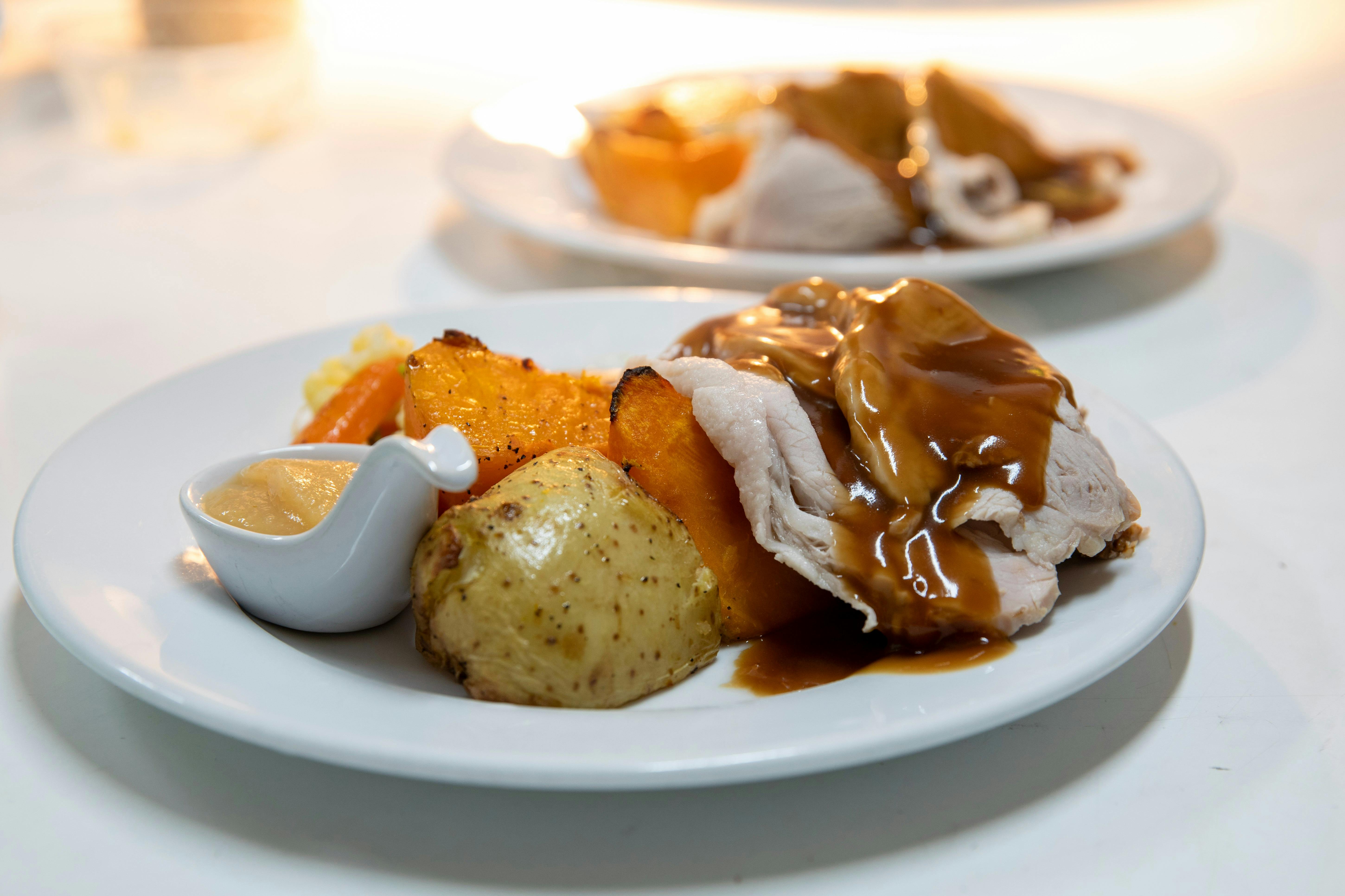 Plates of roast meat and vegetables on a table