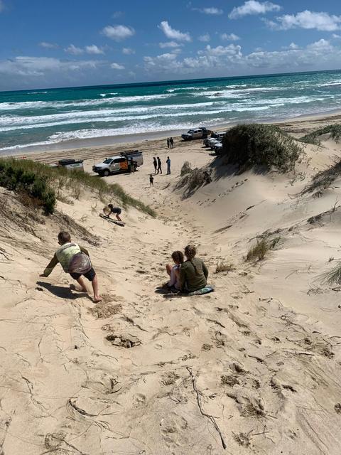 Sandboarding down dunes