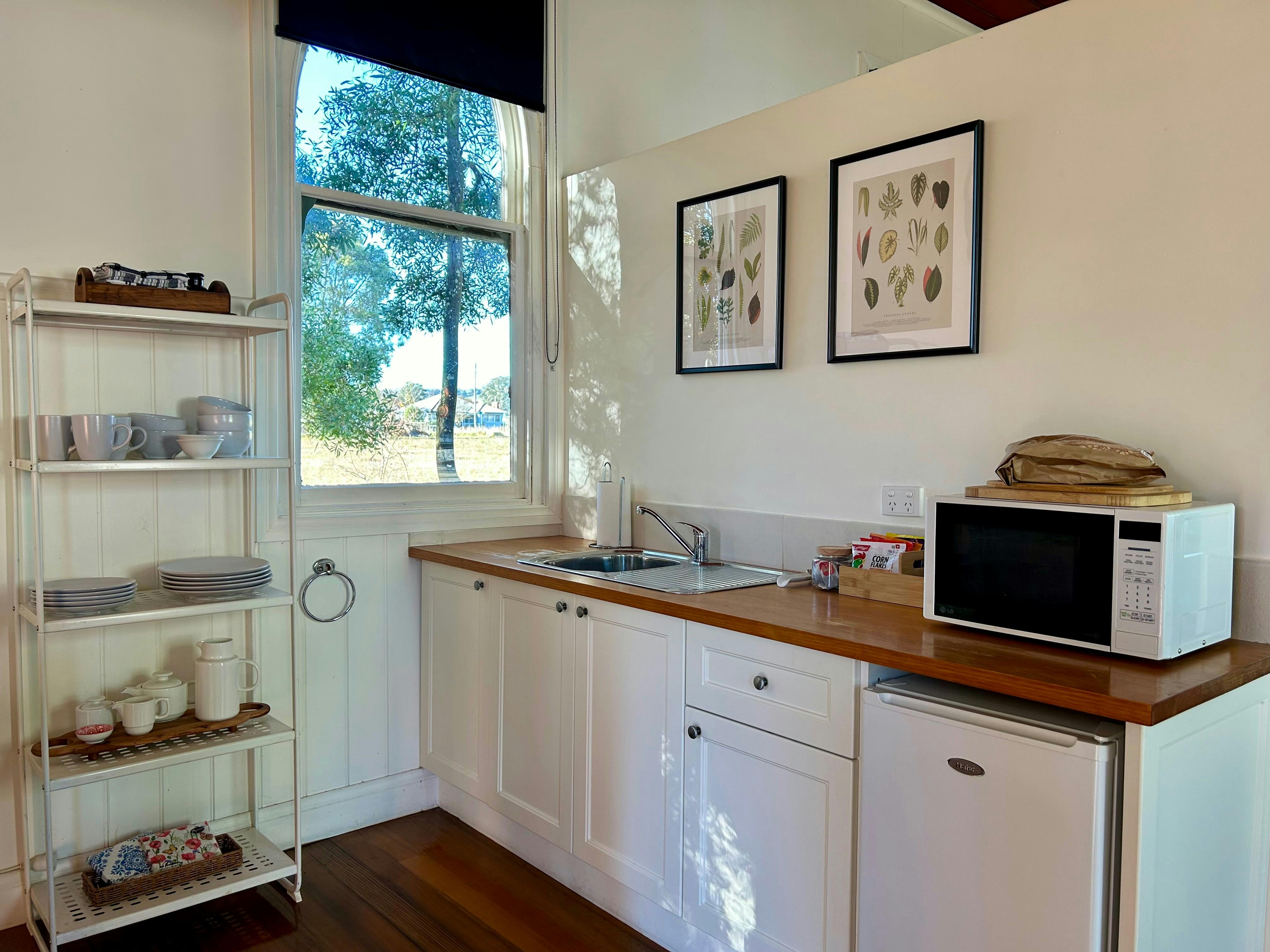 Kitchenette is equipped with microwave, twin stove top, kettle, toaster, bar fridge & cutlery