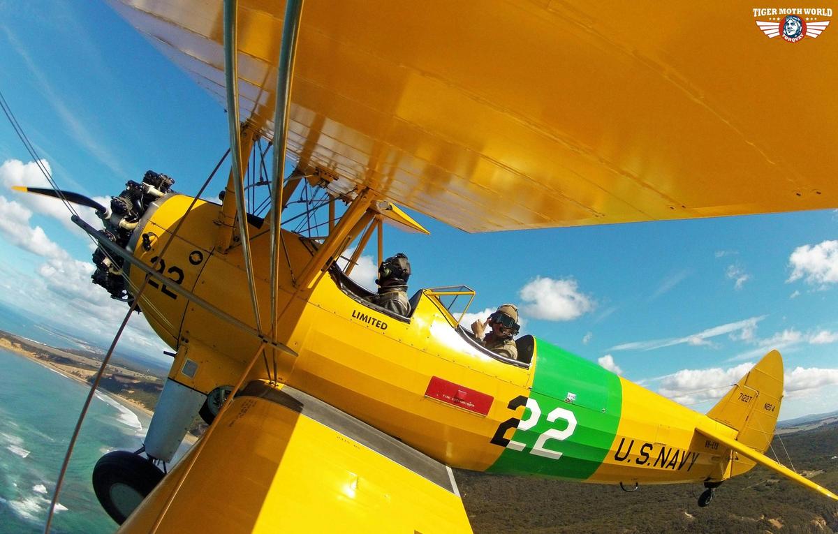 Flying along the coast in a Tiger Moth World WW2 biplane