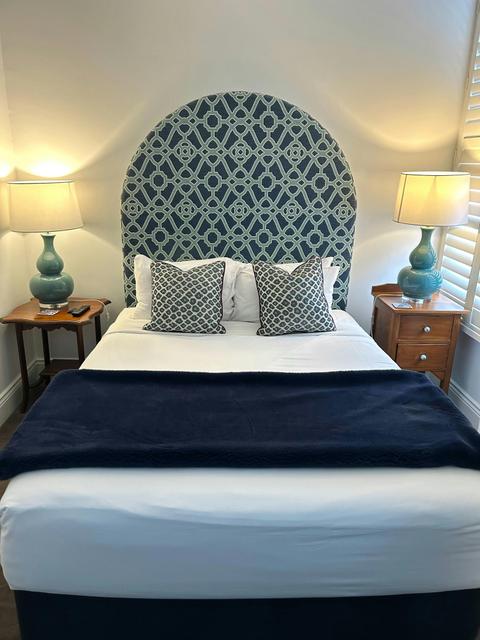 Bedroom featuring bed, bed side tables, lamps