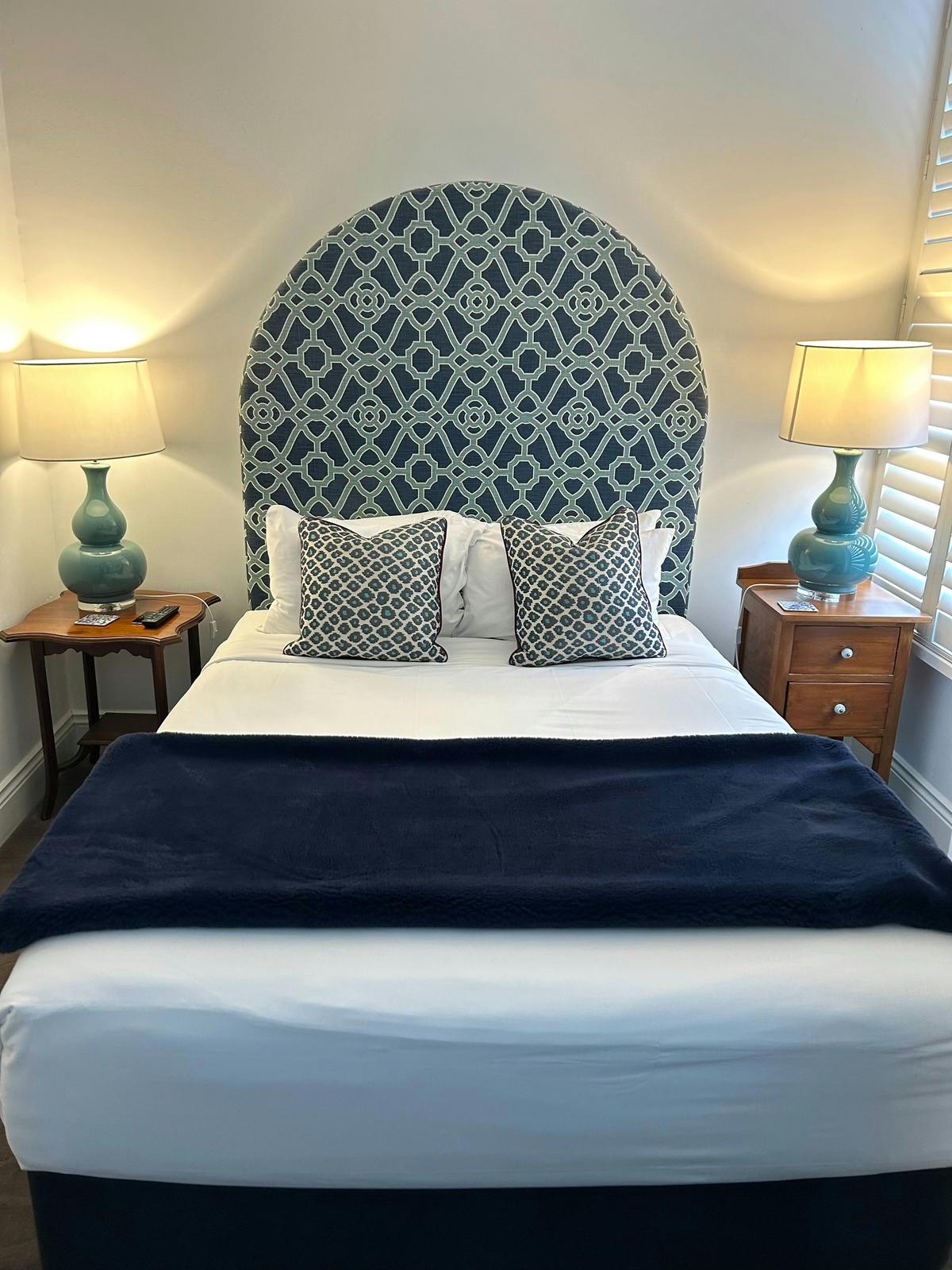 Bedroom featuring bed, bed side tables, lamps