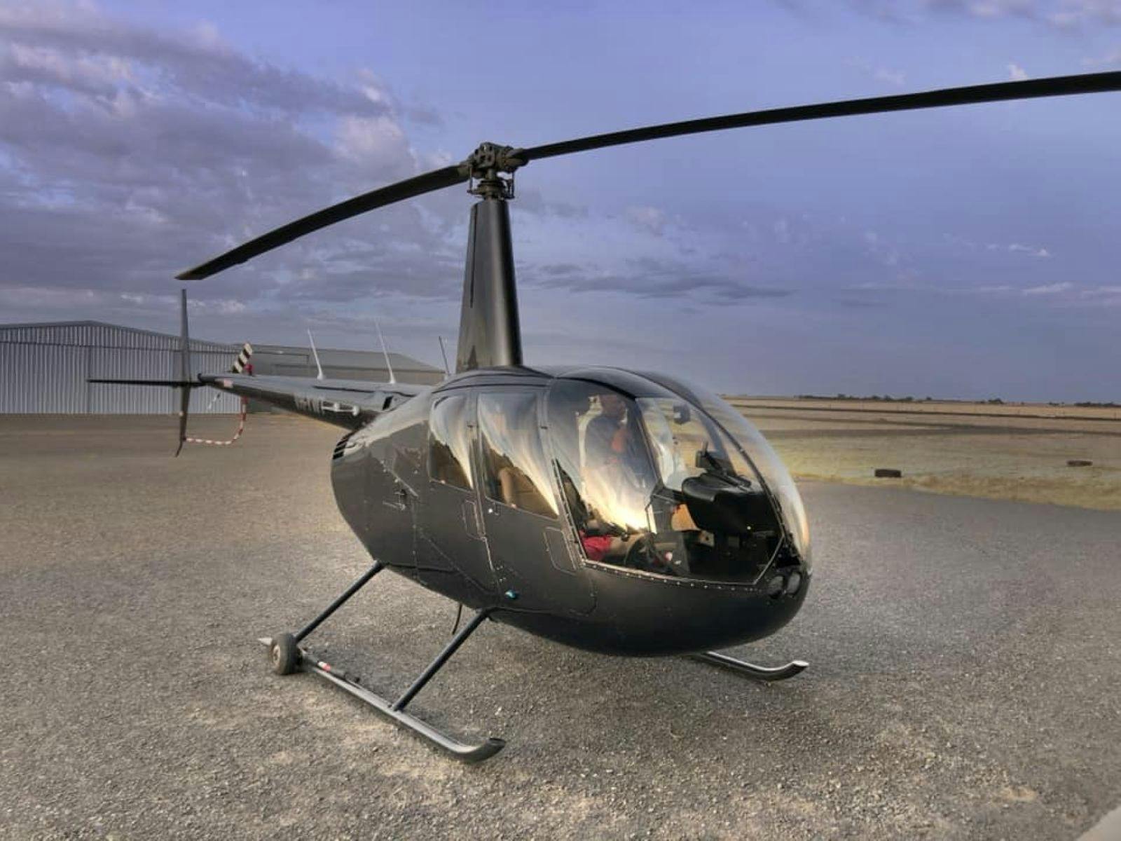 Exterior of a helicopter sitting on the landing pad at the airport