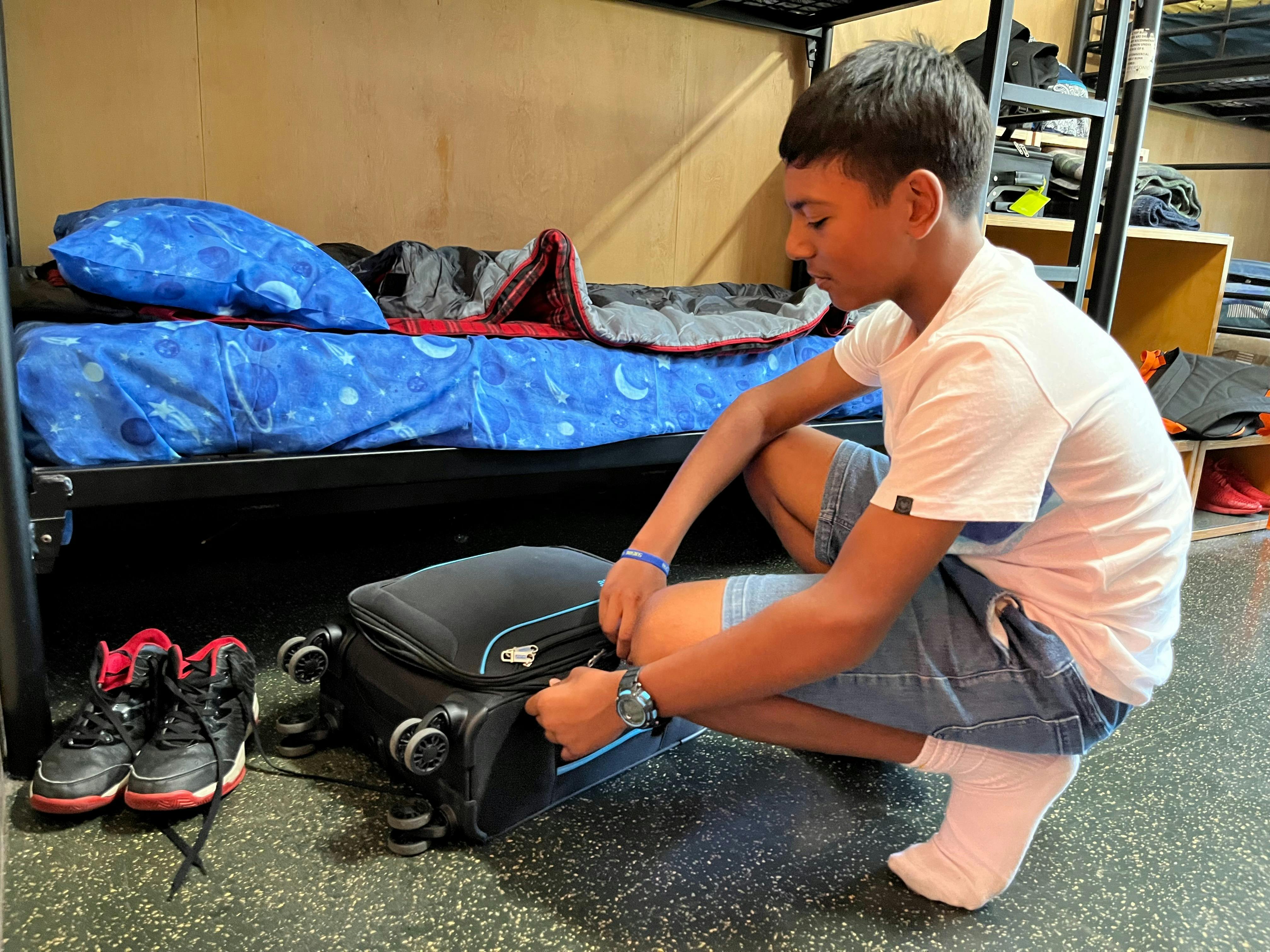 Student unpacking a case at Urban Camp