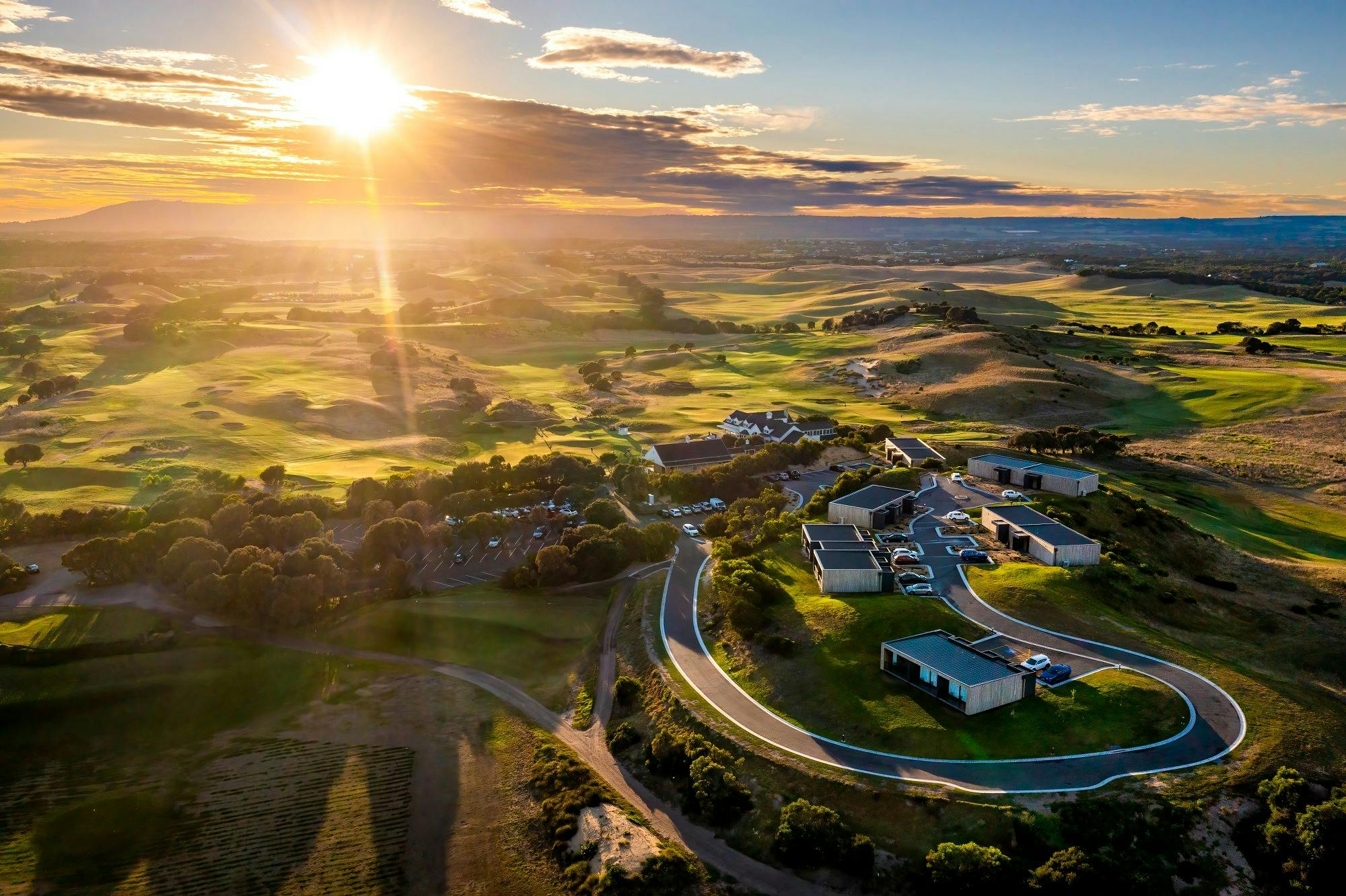 the dunes golf course and links accommodation from above with the sun setting in the background