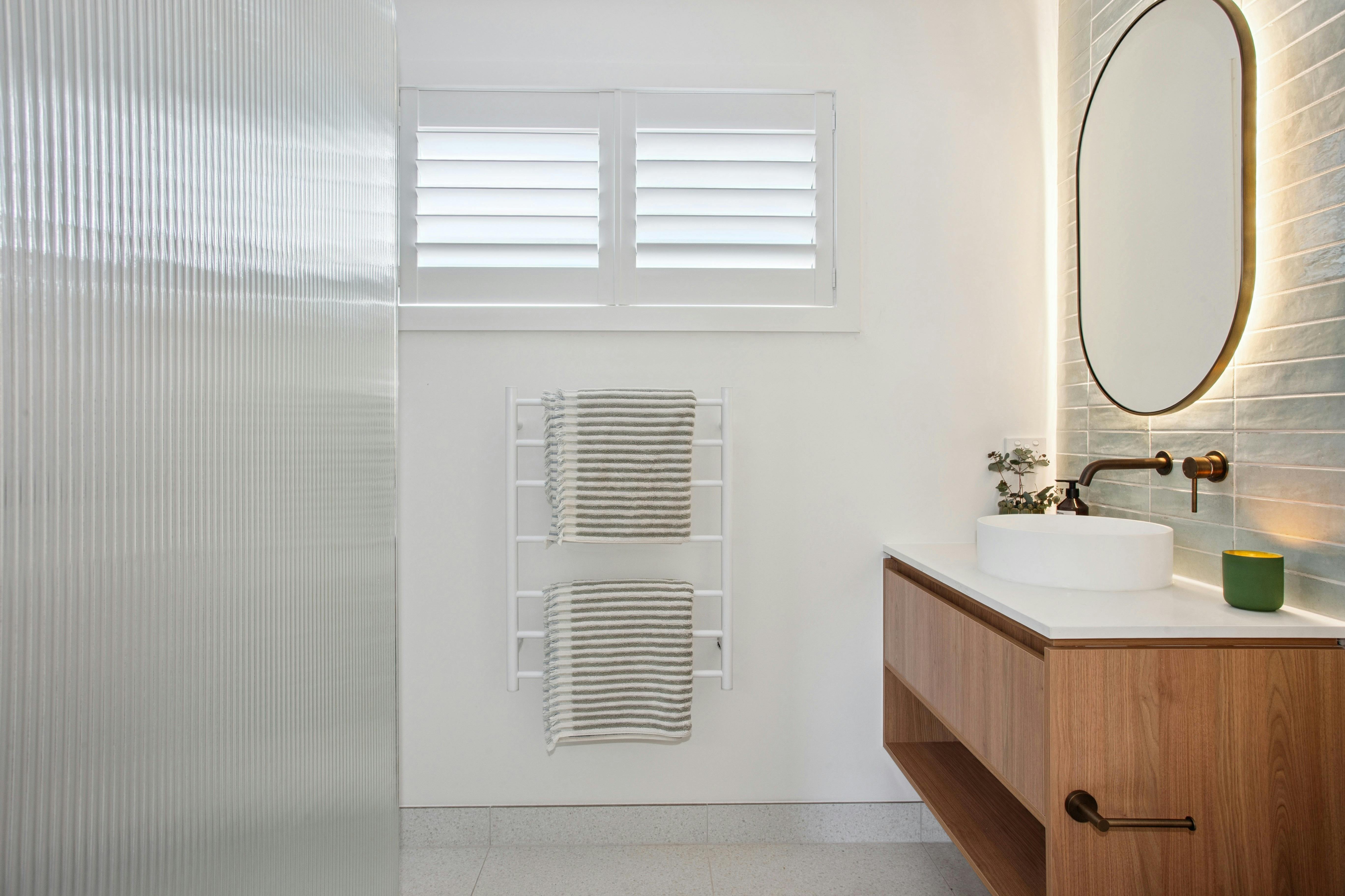Stylish bathroom with feature tiles and modern brushed bronze fittings
