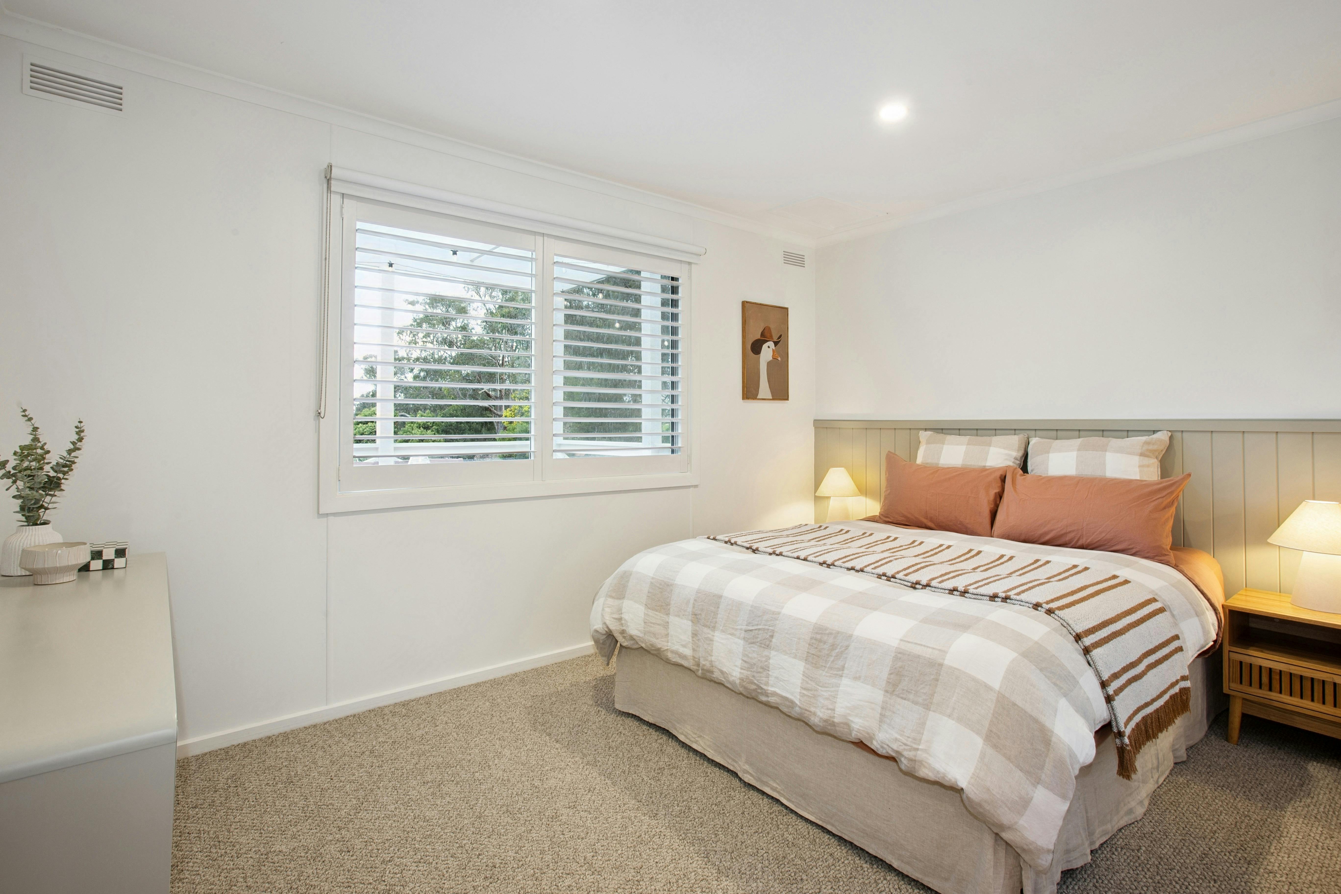 Main bedroom with warm linen bedding and rustic country charm