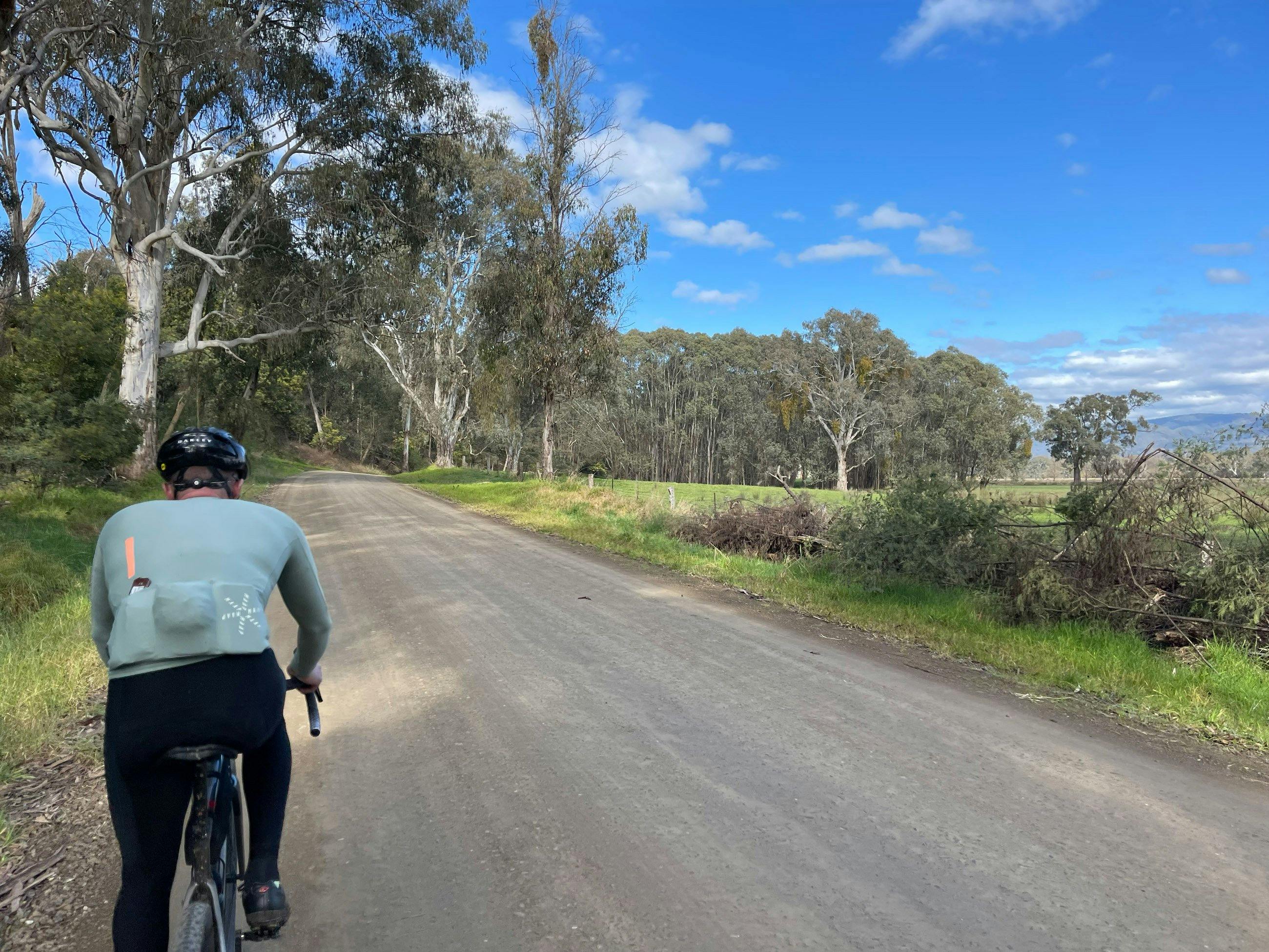 Cyclist on Gravel Road