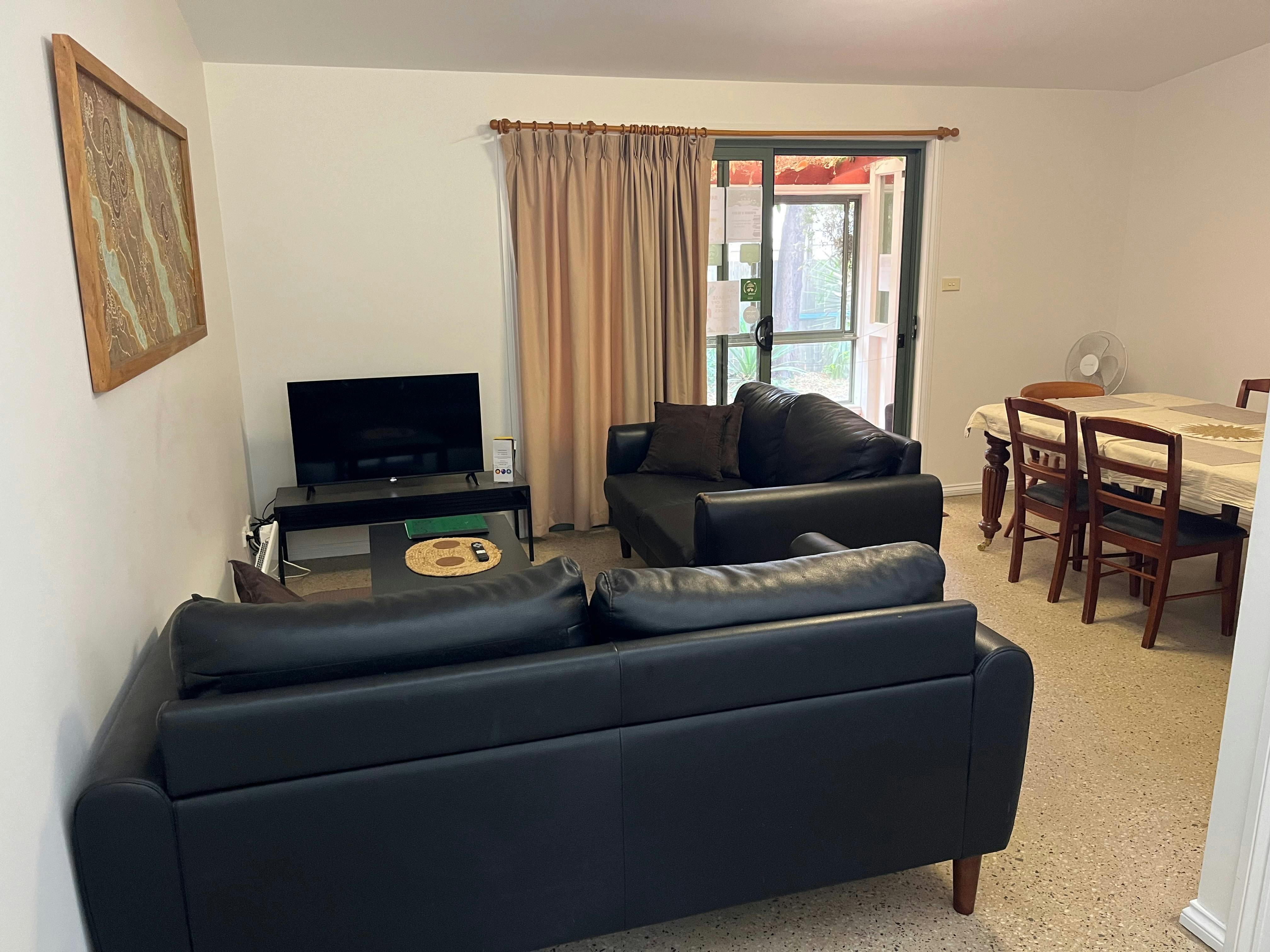 Tim’s Place Apartments-A Green Host Eco Ok The living /  dining room.