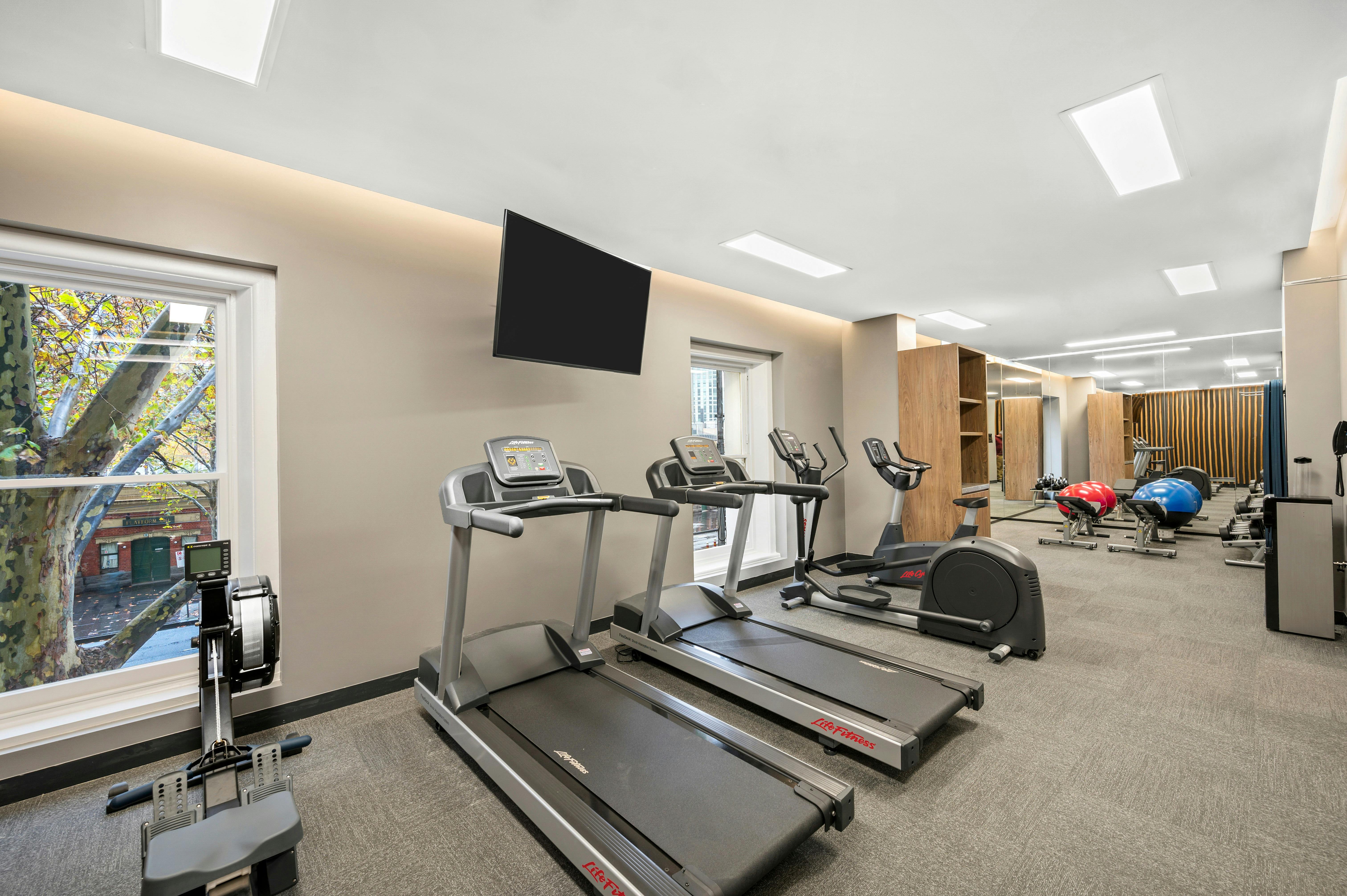 hotel gym including cardio machines and weights