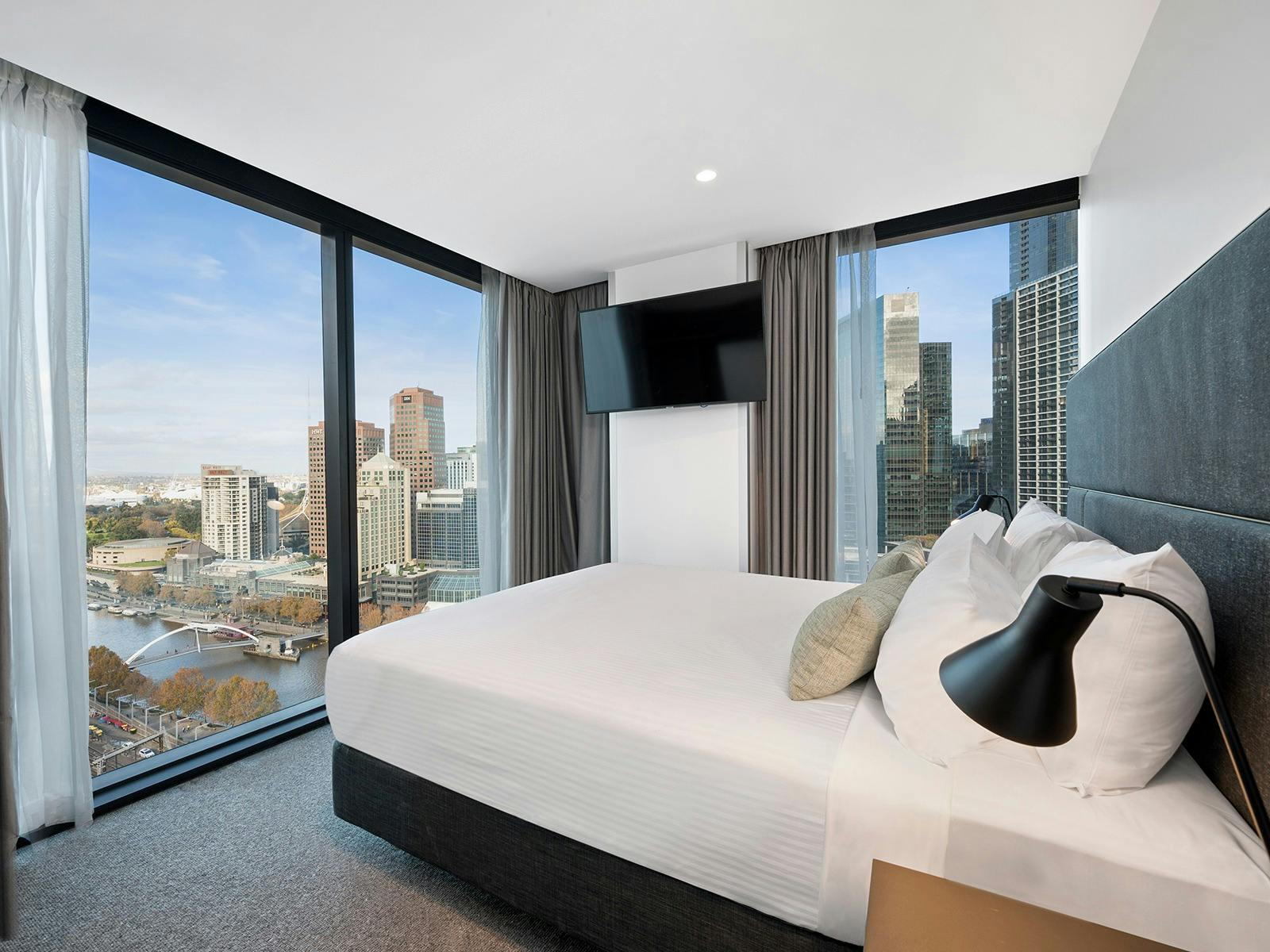 Vibe Hotel Melbourne room with floor to ceiling windows looking out to the city