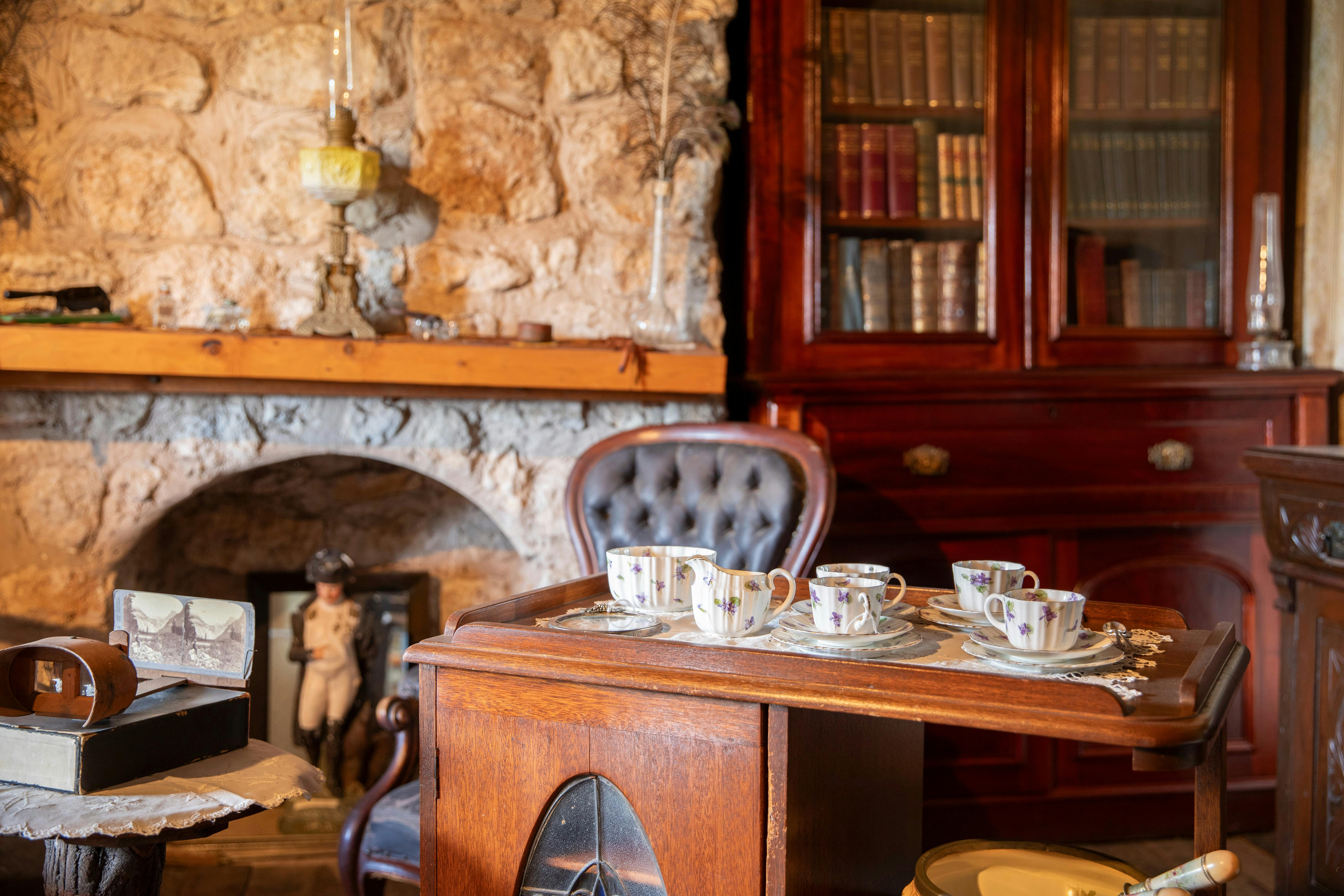 Old fashioned leather chair in front of a stone fireplace