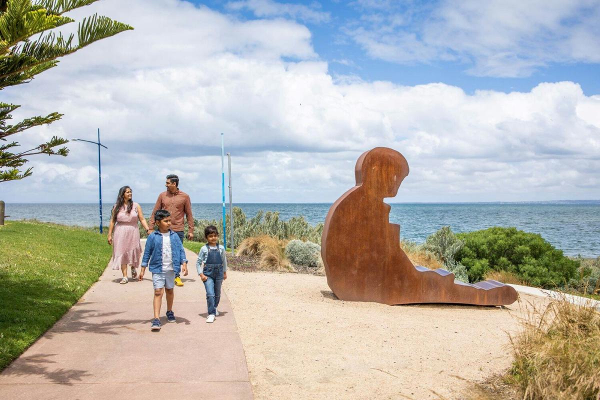 Family walking beside sculpture at Werribee South Foreshore