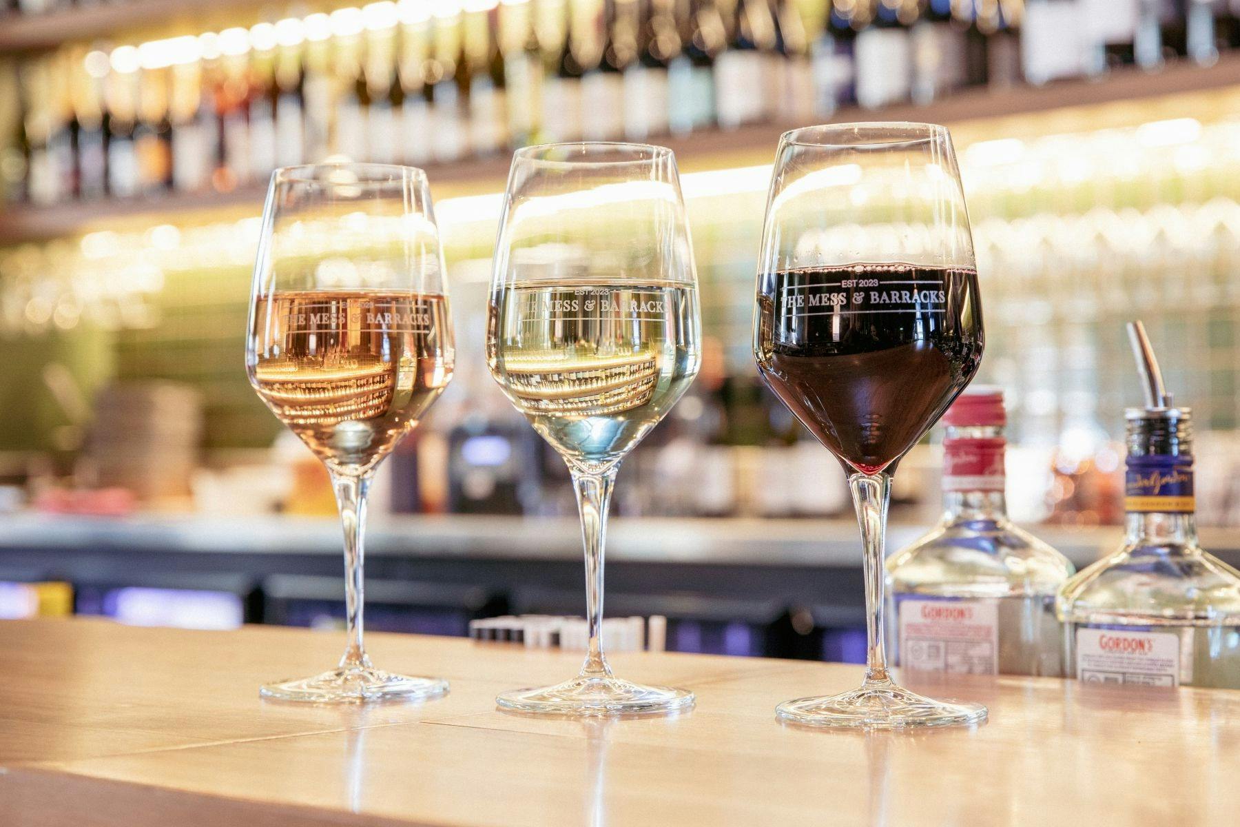 3 glasses of wine on a bar