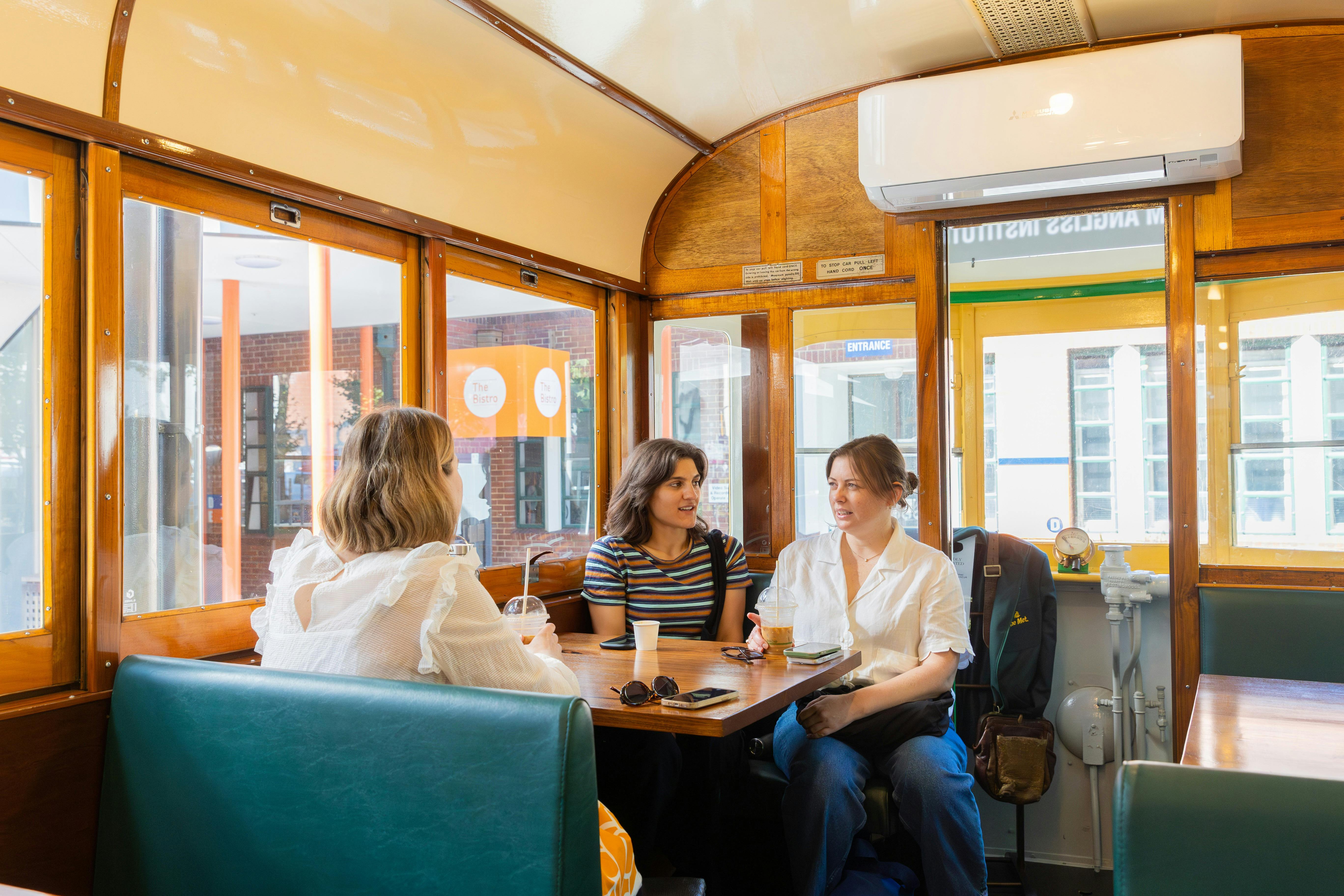 Patrons enjoying coffee inside the Tram Café