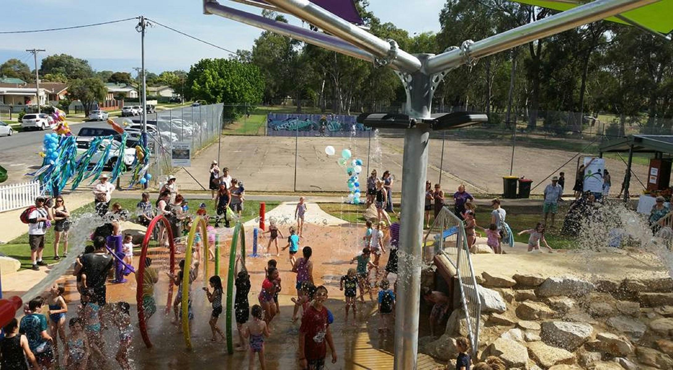 Kids playing in the water, and families enjoying the splash park.