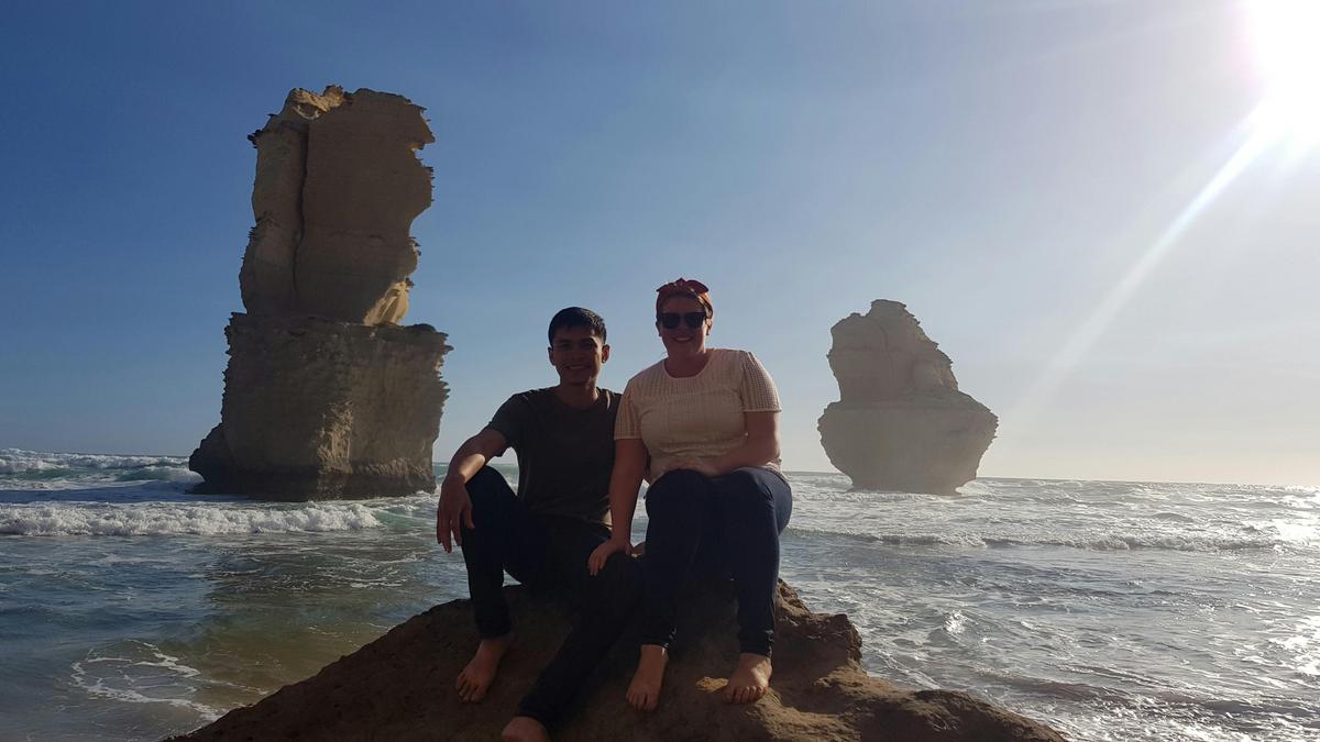 Couple on beach with Apostles Backdrop