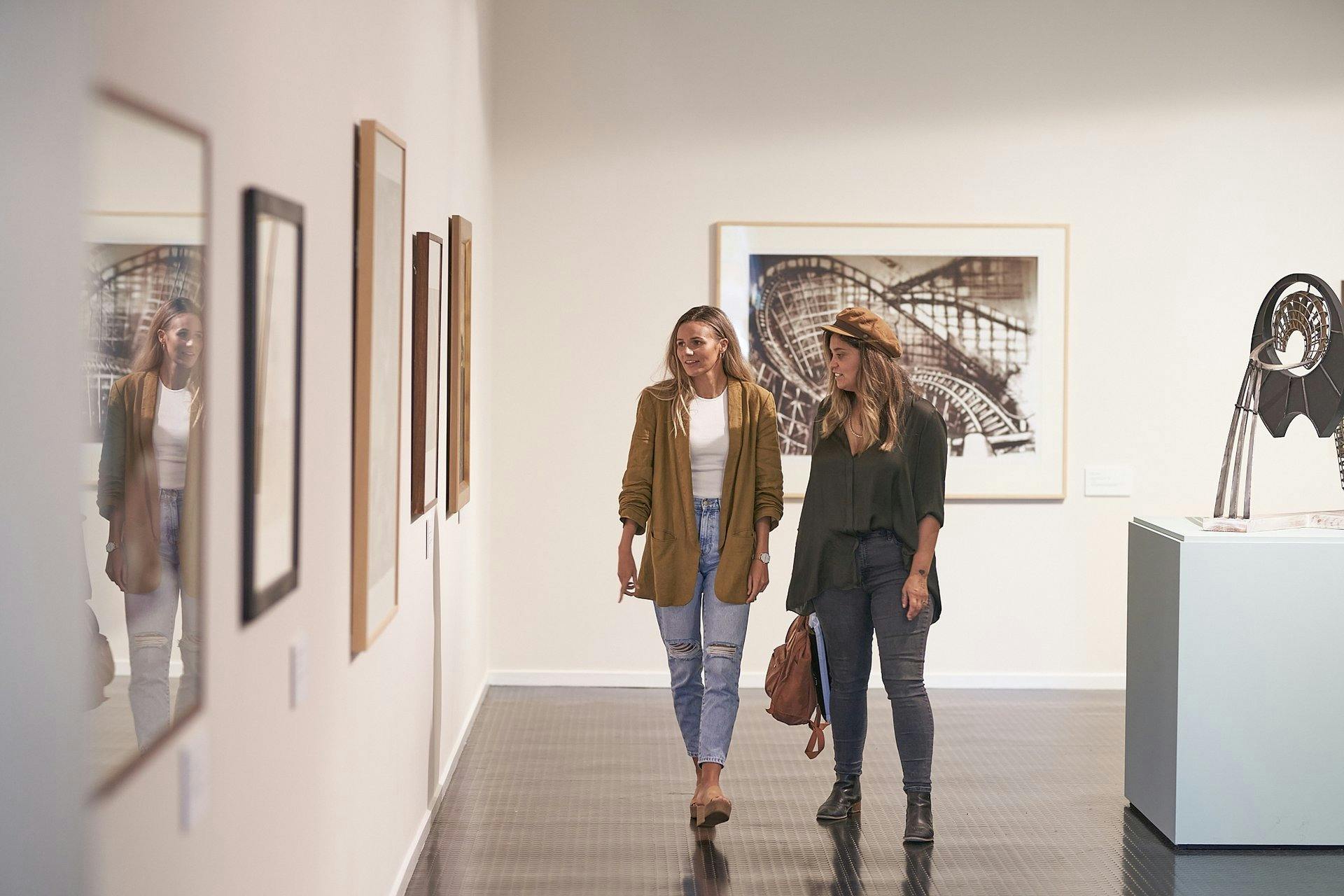 Two women looking at artwork
