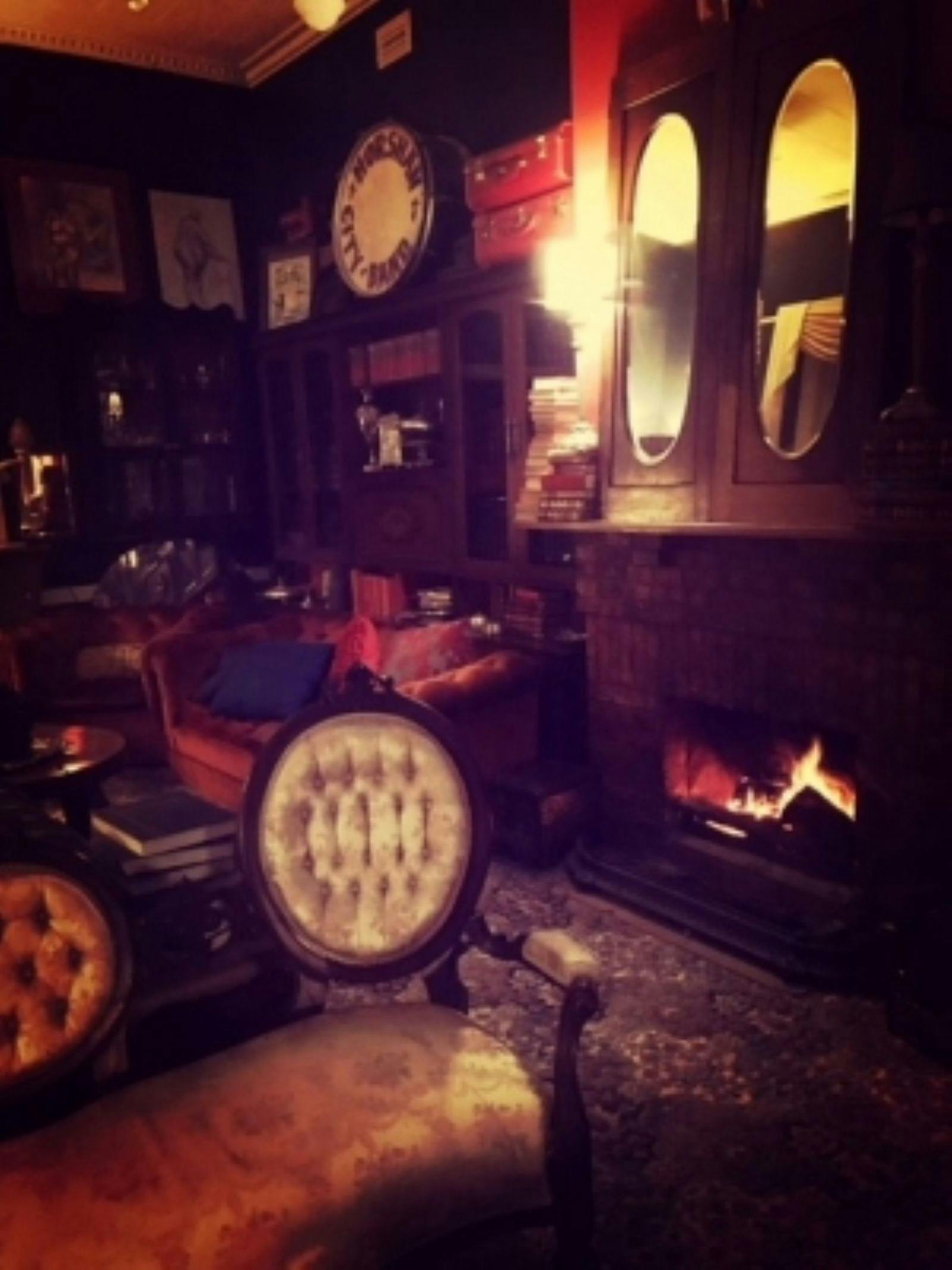 Chairs in a dimly lit room with a fireplace in the background