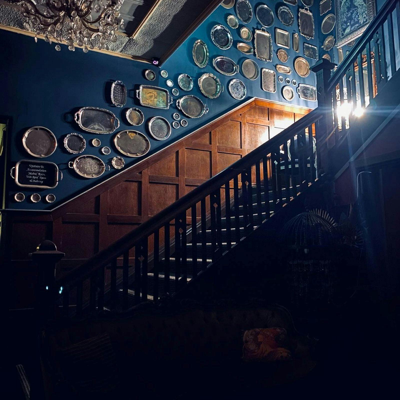 Staircase with silver platters attached to the wall