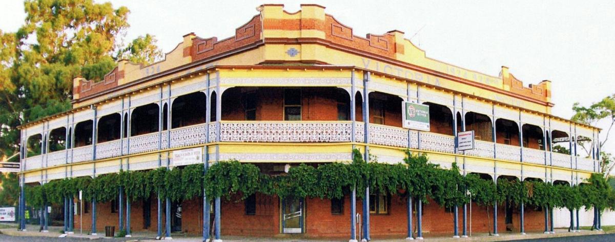 Exterior of a grand old pub with a large wide balcony