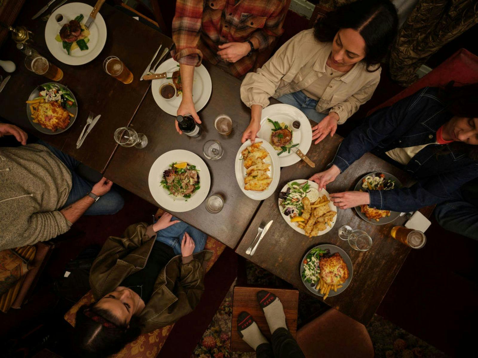 Aerial Image of people sitting at tables with food and enjoying a meal